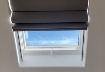 Somfy motorized Roman shades fully closed on hall skylight windows in Beverly Hills, providing elegant light blocking and privacy.